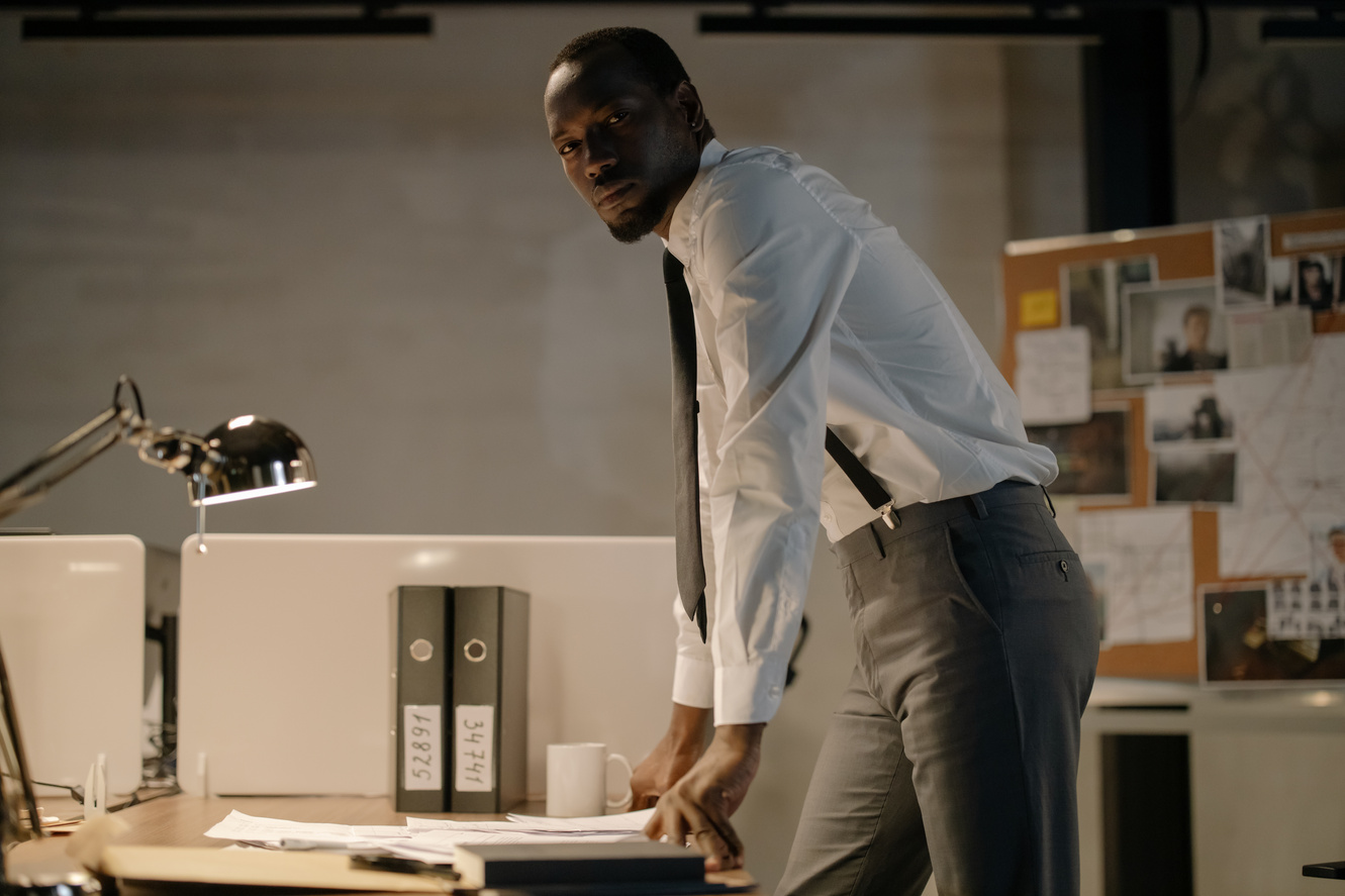 Man Wearing White Long Sleeves Standing Near Work Desk